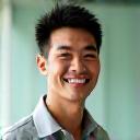 Portrait of Coach David Lee, an East Asian man with an athletic build and an encouraging smile.