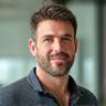 Portrait of Mark Johnson, a certified strength and conditioning specialist, looking thoughtful and approachable.